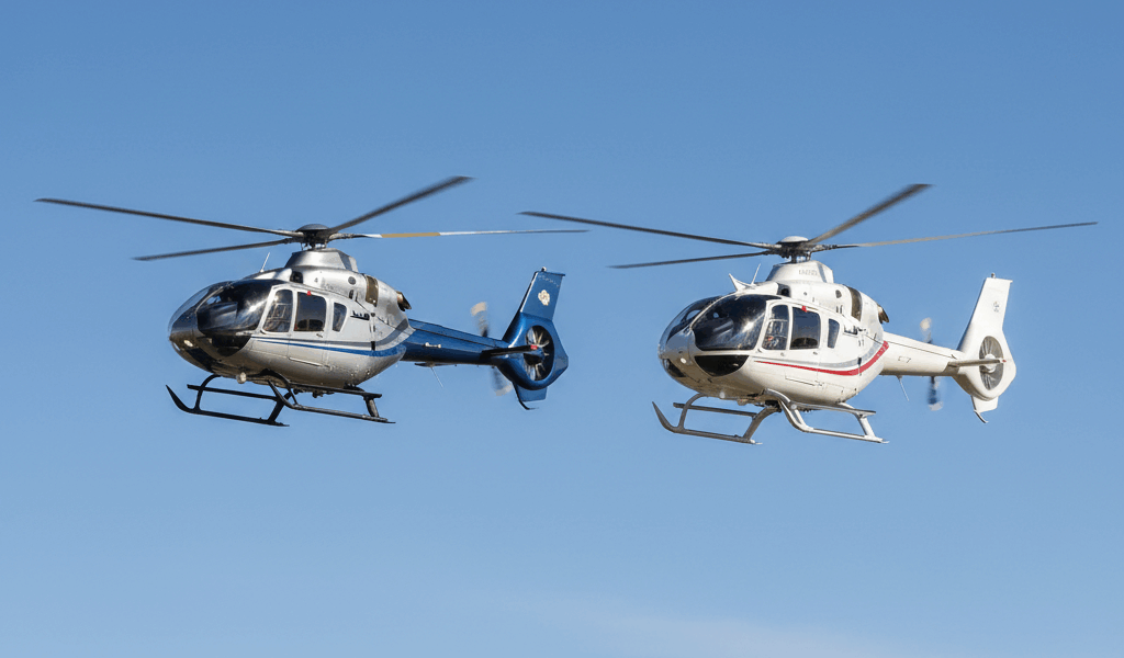 Bell 505 and Robinson R66 helicopters side-by-side comparison in flight