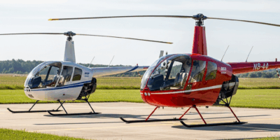 robinson r22 and r44 helicopters parked side by side on a he 20260331 130003